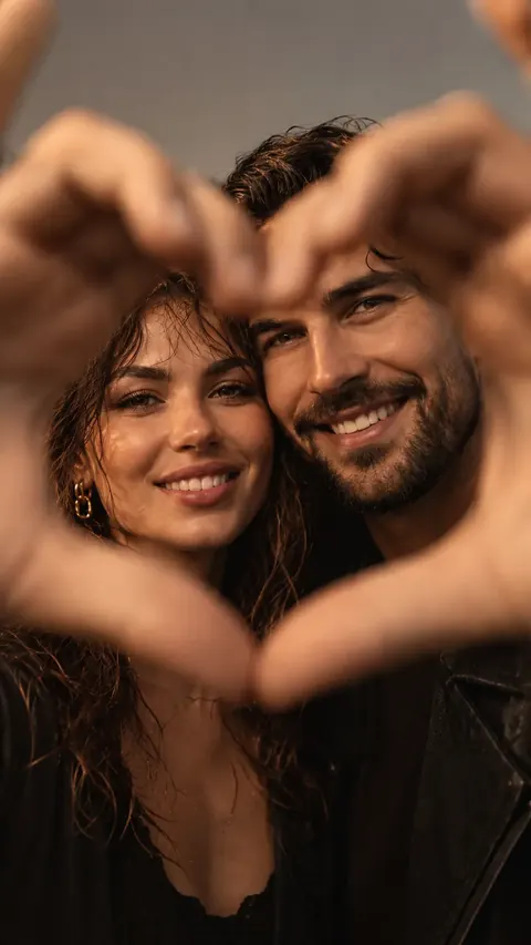 Couple taking a heart selfie